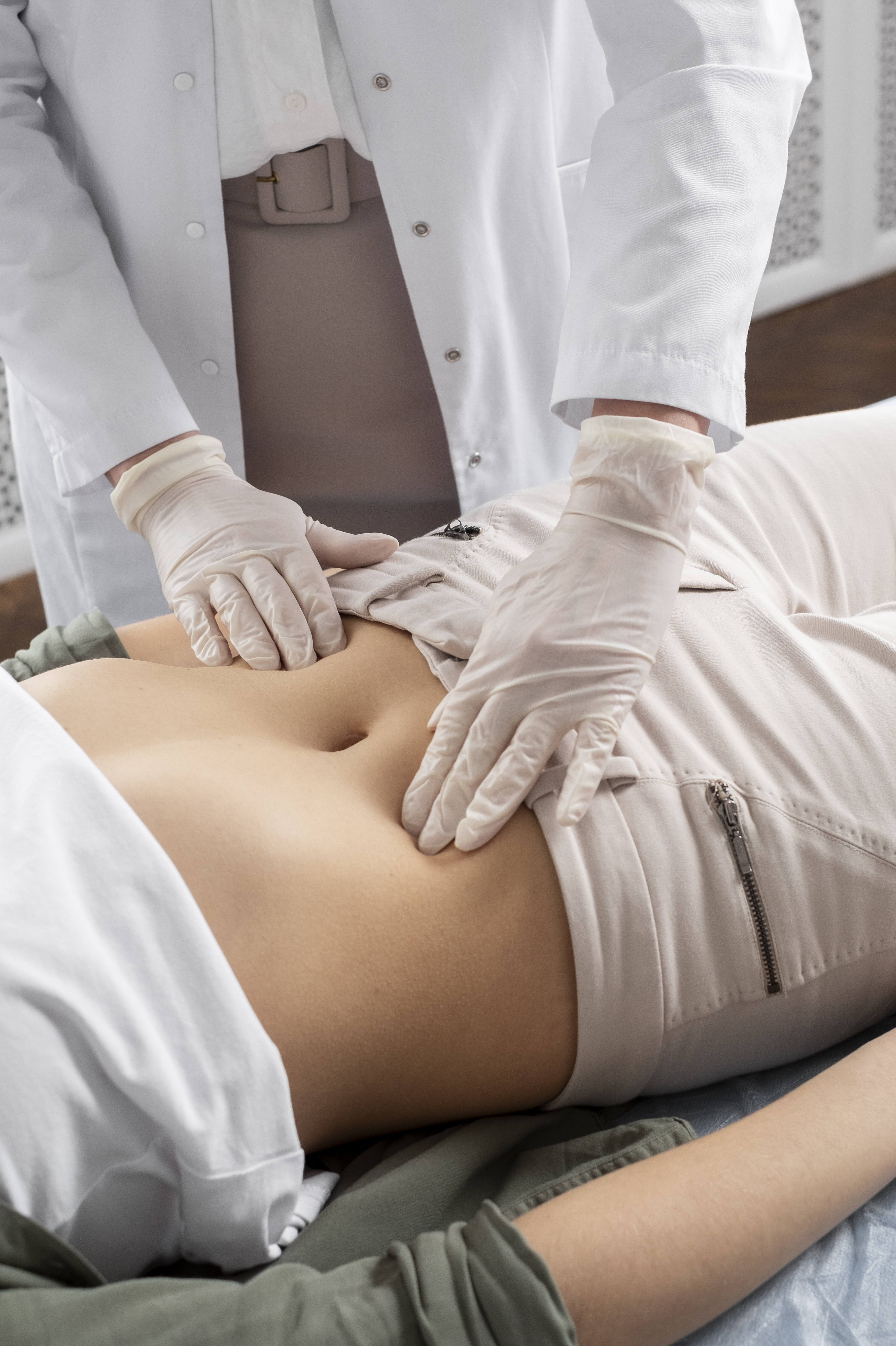 Woman holding hand over stomach after substantial weight loss